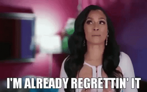 A Woman Is Saying `` I 'M Already Regrettin ' It '' While Standing In A Pink Room . GIF