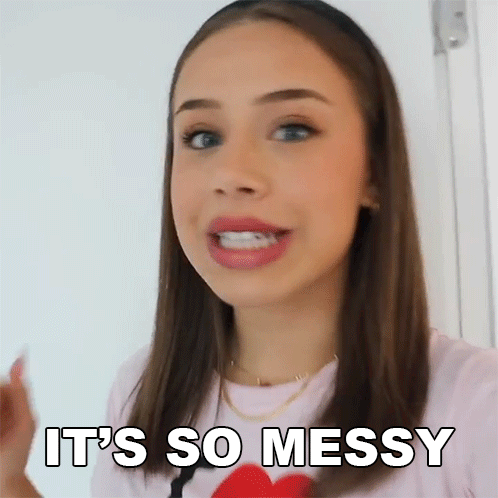 A Woman Is Saying It 'S So Messy While Holding A Red Heart . GIF