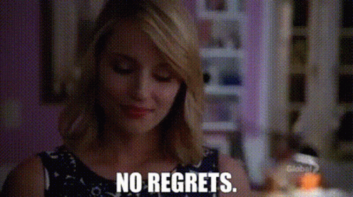 A Woman Is Saying No Regrets While Looking Down At Something . GIF