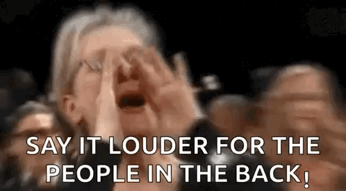 A Woman Is Screaming In A Crowd Of People While Saying `` Say It Louder For The People In The Back '' . GIF