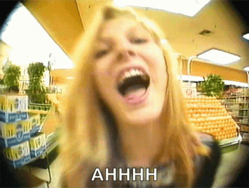 A Woman Is Screaming In A Grocery Store With The Word Ahhhh Above Her GIF