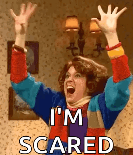 A Woman Is Screaming With Her Arms In The Air And The Words I 'M Scared Above Her GIF