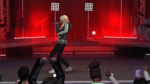 A Woman Is Singing Into A Microphone On A Stage In Front Of A Crowd GIF