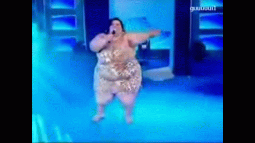 A Woman Is Singing Into A Microphone On A Stage With A Blue Background That Says ' Guigui ' On It GIF