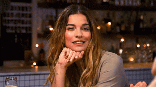 Woman Smiling Sitting At Bar GIF