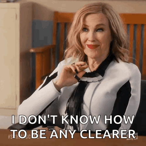 A Woman Is Sitting At A Desk And Says " I Don 'T Know How To Be Any Clearer " GIF