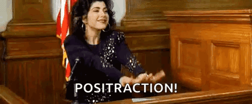 A Woman Is Sitting At A Desk In A Courtroom With Her Hands Outstretched And The Words Posttraction Written Above Her . GIF
