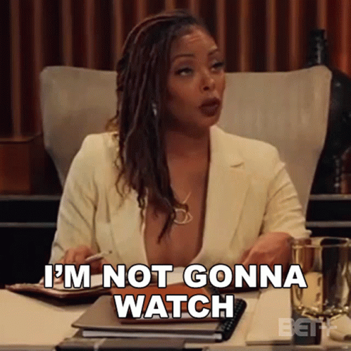 A Woman Is Sitting At A Desk With A Pen In Her Hand And Says I 'M Not Gonna Watch . GIF
