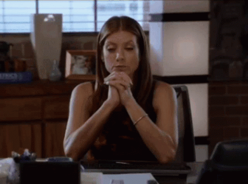 Woman Sitting At Desk With Folded Hands GIF