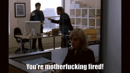A Woman Is Sitting At A Desk With The Words You 'Re Motherfucking Fired GIF
