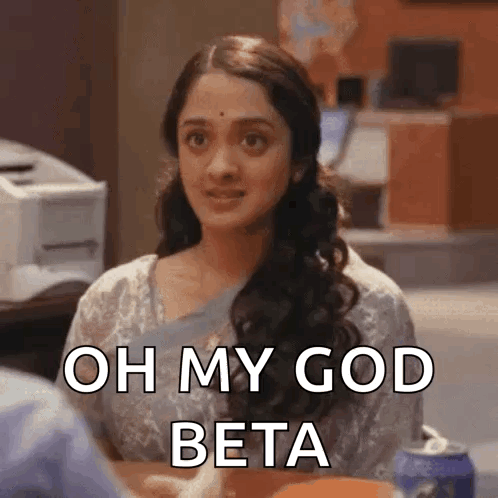 a woman is sitting at a table and says oh my god beta