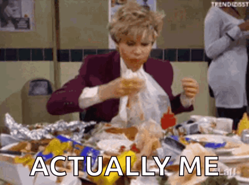 A Woman Is Sitting At A Table Eating Food And The Words Actually Me Are Visible . GIF