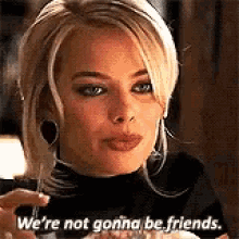 A Woman Is Sitting At A Table Holding A Glass Of Wine And Saying `` We 'Re Not Gonna Be Friends . '' GIF
