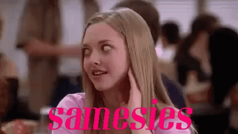 A Woman Is Sitting At A Table In A Restaurant With The Word Samesies Written On The Bottom Of Her Face . GIF