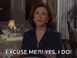 A Woman Is Sitting At A Table Saying `` Excuse Me ? Yes , I Do ! `` GIF