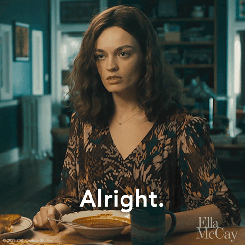 A Woman Is Sitting At A Table With A Bowl Of Soup And A Mug Of Coffee And The Word Alright Is Above Her GIF