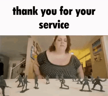A Woman Is Sitting At A Table With A Bunch Of Toy Soldiers In Front Of Her . GIF