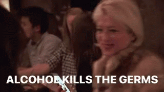 A Woman Is Sitting At A Table With A Cell Phone In Her Hand And A Group Of People Are Sitting Around Her . GIF