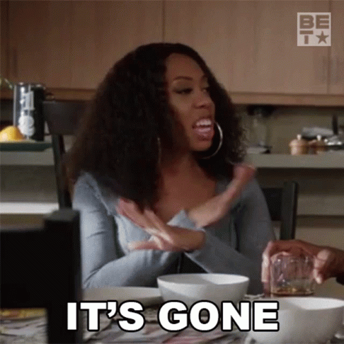 A Woman Is Sitting At A Table With A Glass Of Whiskey And A Bowl Of Food And Says It 'S Gone GIF