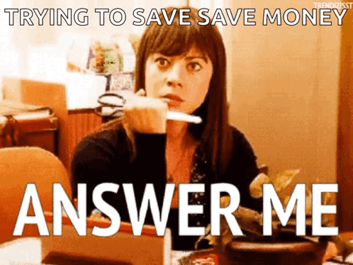A Woman Is Sitting At A Table With A Knife In Her Hand And The Words " Trying To Save Save Money Answer Me " Behind Her GIF