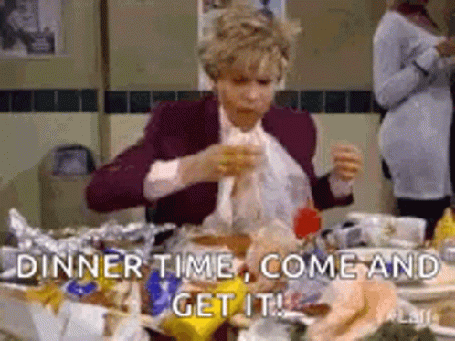 A Woman Is Sitting At A Table With A Lot Of Food And Eating . GIF