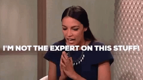 A Woman Is Sitting At A Table With Her Hands Folded And Says `` I 'M Not The Expert On This Stuff ! '' GIF