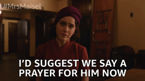 A Woman Is Sitting At A Table With The Words I 'D Suggest We Say A Prayer For Him Now GIF