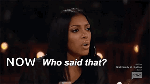 A Woman Is Sitting At A Table With The Words Now Who Said That Above Her GIF