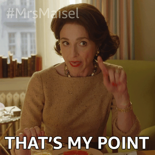 A Woman Is Sitting At A Table With The Words That 'S My Point Written Below Her GIF