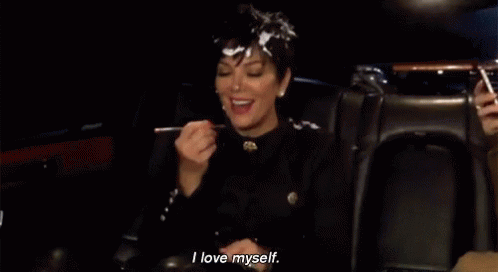 A Woman Is Sitting In A Car With A Spoon In Her Mouth . GIF