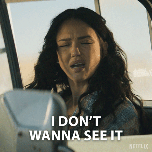A Woman Is Sitting In A Car With Her Eyes Closed And Says " I Don 'T Wanna See It " GIF