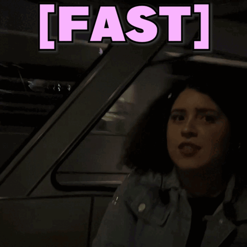 A Woman Is Sitting In A Car With The Words Fast Behind Her GIF