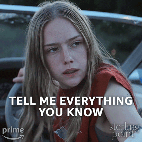 a woman is sitting in a car with the words tell me everything you know behind her