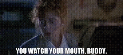 A Woman Is Sitting In A Car With The Words `` You Watch Your Mouth , Buddy '' Written On The Screen . GIF