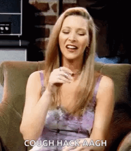 A Woman Is Sitting In A Chair And Laughing . GIF