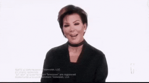 A Woman Is Sitting In A Chair Holding A Tissue To Her Face . GIF