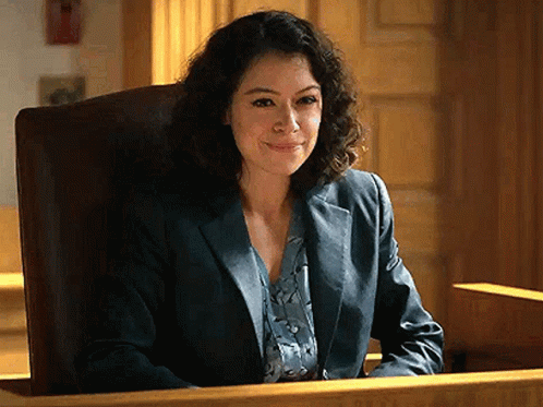 Woman Sitting In Courtroom Smiling GIF