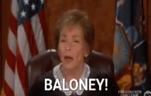 A Woman Is Sitting In A Chair In Front Of An American Flag And Saying Baloney . GIF