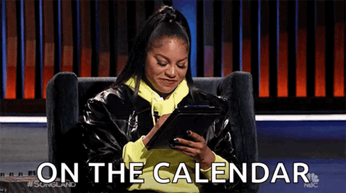 A Woman Is Sitting In A Chair Looking At A Tablet And The Words On The Calendar Are Visible . GIF