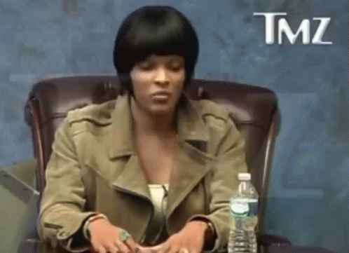 A Woman Is Sitting In A Chair With A Bottle Of Water In Front Of Her And The Word Tmz On The Bottom GIF