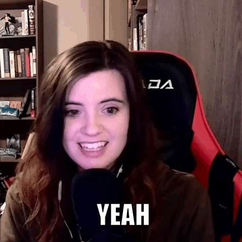 A Woman Is Sitting In A Chair With A Microphone And The Word Yeah Is On Her Face . GIF