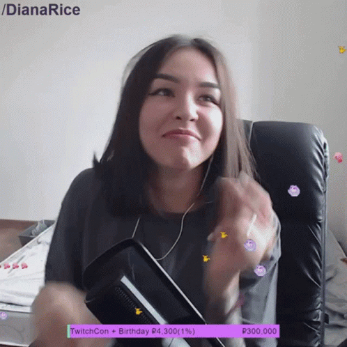 A Woman Is Sitting In A Chair With A Purple Twitchcon Birthday Banner Behind Her GIF