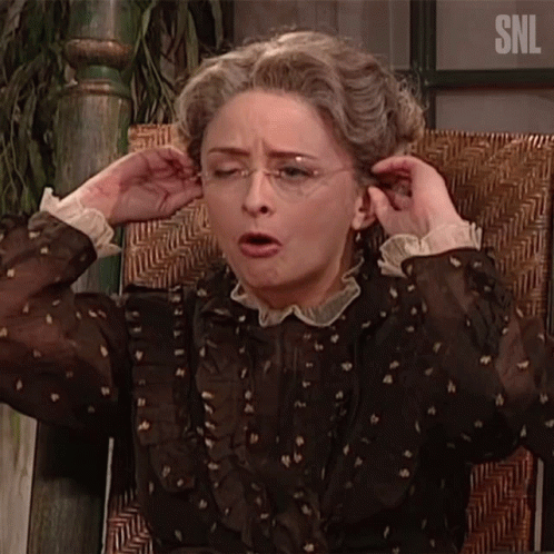 A Woman Is Sitting In A Chair With A Snl Logo On The Bottom GIF