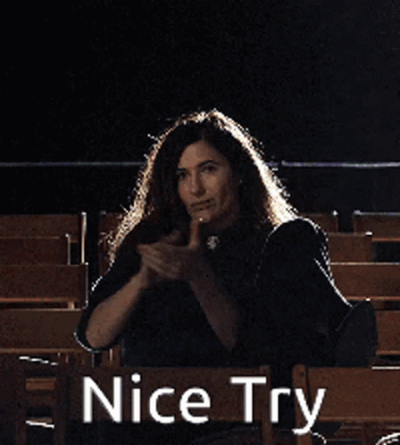 A Woman Is Sitting In A Chair With Her Arms In The Air And The Words Nice Try Behind Her GIF