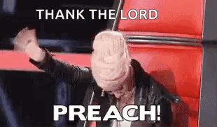 A Woman Is Sitting In A Chair With Her Hands In The Air And A Sign That Says Thank The Lord Preach . GIF