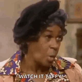 A Woman Is Sitting In A Chair With Her Mouth Open And Says `` Watch It Taffy ! '' GIF