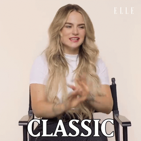 A Woman Is Sitting In A Chair With The Word Classic Written On The Screen GIF