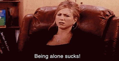 A Woman Is Sitting In A Chair With The Words `` Being Alone Sucks '' Written On The Bottom . GIF
