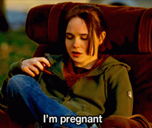 A Woman Is Sitting In A Chair With The Words I 'M Pregnant Written On The Bottom GIF