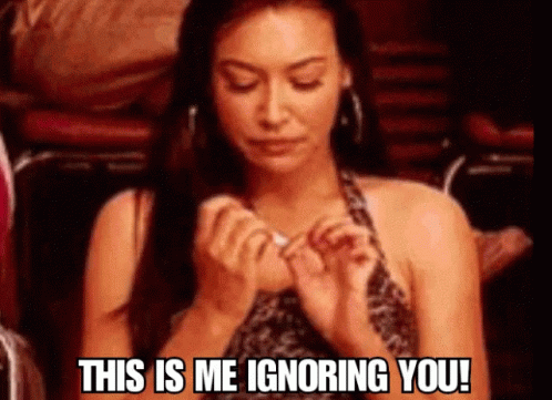 A Woman Is Sitting In A Chair With The Words This Is Me Ignoring You GIF